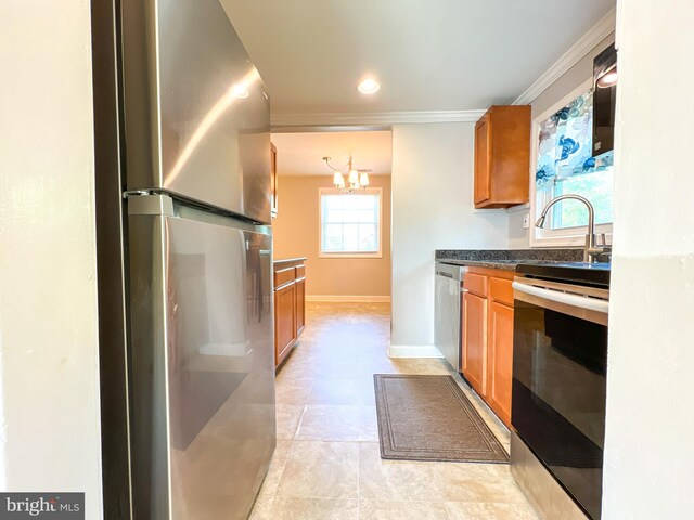 131 Arundel Rd, Pasadena, MD 21122 - kitchen with appliances with stainless steel finishes, brown cabinets, a chandelier, ornamental molding, and dark countertops