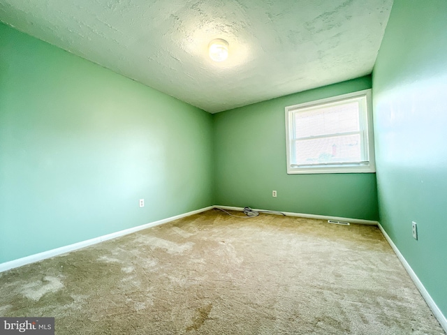131 Arundel Rd, Pasadena, MD 21122 - spare room with carpet floors, baseboards, and a textured ceiling