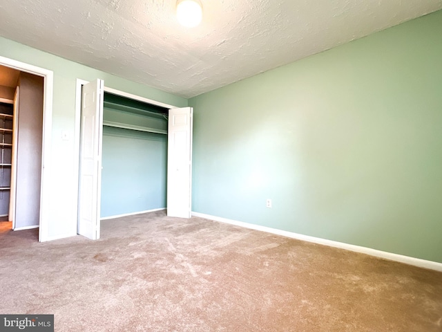 131 Arundel Rd, Pasadena, MD 21122 - unfurnished bedroom featuring carpet, baseboards, a closet, and a textured ceiling