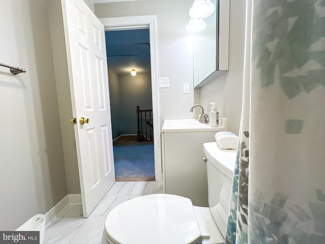 131 Arundel Rd, Pasadena, MD 21122 - bathroom with toilet, vanity, and baseboards