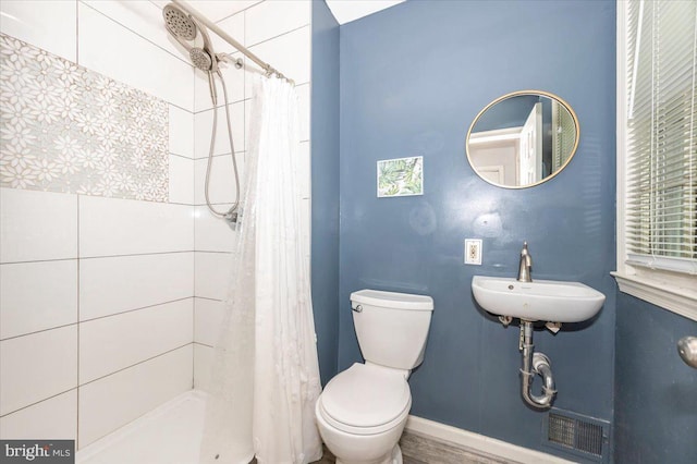 4117 Charley Forest St, Olney, MD 20832 - bathroom with a sink, tiled shower, toilet, and baseboards