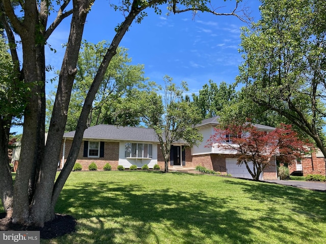 4117 Charley Forest St, Olney, MD 20832 - view of front facade featuring brick siding, an attached garage, a front lawn, and driveway