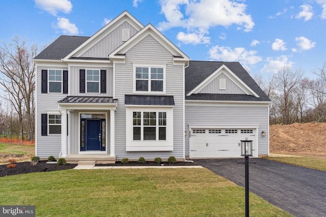 4338 Taviston Ct E, Emmaus, PA 18049 - view of front of property with board and batten siding, asphalt driveway, a garage, a front yard, and roof with shingles