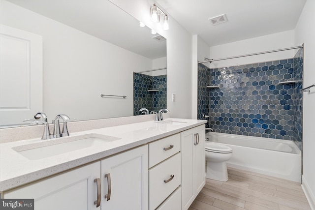 4338 Taviston Ct E, Emmaus, PA 18049 - bathroom with double vanity, wood finished floors, tub / shower combination, and toilet