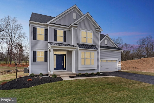 4338 Taviston Ct E, Emmaus, PA 18049 - view of front of property featuring board and batten siding, central AC, driveway, and a lawn