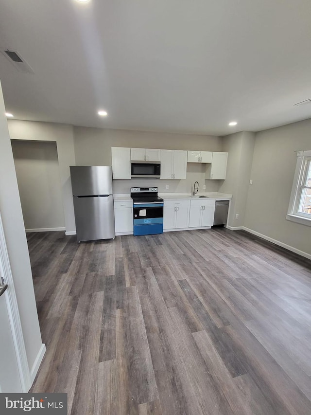 132 N 50th St, Philadelphia, PA 19139 - kitchen featuring stainless steel appliances, a sink, white cabinets, light countertops, and recessed lighting