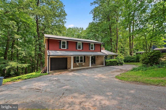 19 Norris Run Ct, Reisterstown, MD 21136 - traditional-style house with a porch, asphalt driveway, and an attached garage