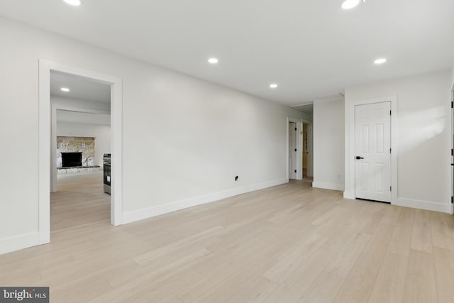 3835 Dresher Rd, Bensalem, PA 19020 - spare room featuring light wood-style floors, baseboards, recessed lighting, and a fireplace