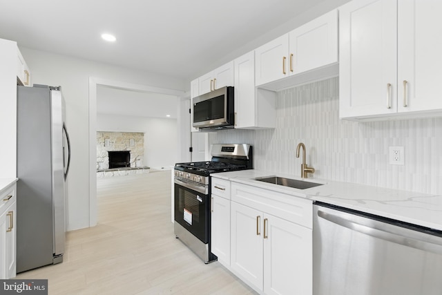 3835 Dresher Rd, Bensalem, PA 19020 - kitchen featuring stainless steel appliances, a sink, tasteful backsplash, white cabinetry, and light stone counters
