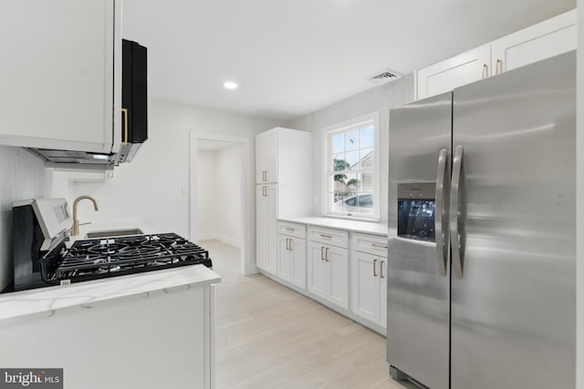 3835 Dresher Rd, Bensalem, PA 19020 - kitchen with stainless steel fridge with ice dispenser, light stone countertops, light wood finished floors, white cabinetry, and recessed lighting