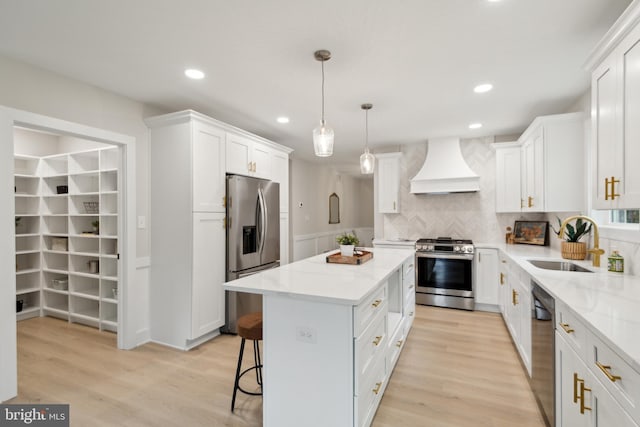 925 Merrick Ave, Haddon Twp, NJ 8108 - kitchen with stainless steel appliances, custom exhaust hood, a kitchen island, a sink, and white cabinetry