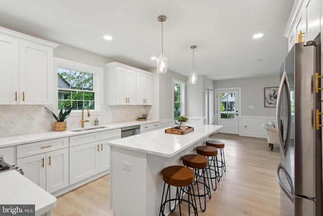 925 Merrick Ave, Haddon Twp, NJ 8108 - kitchen featuring a sink, appliances with stainless steel finishes, plenty of natural light, a center island, and wainscoting