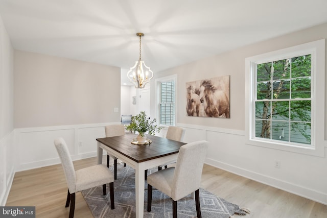 925 Merrick Ave, Haddon Twp, NJ 8108 - dining room featuring light wood-type flooring, a chandelier, a wainscoted wall, and a decorative wall