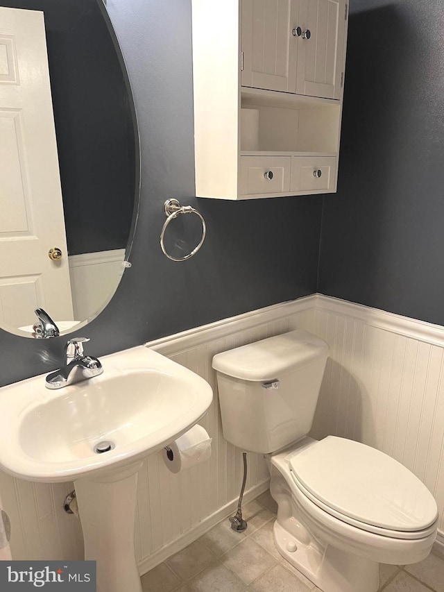 2720 Bellforest Ct Unit 201, Vienna, VA 22180 - bathroom featuring a wainscoted wall, toilet, and a sink