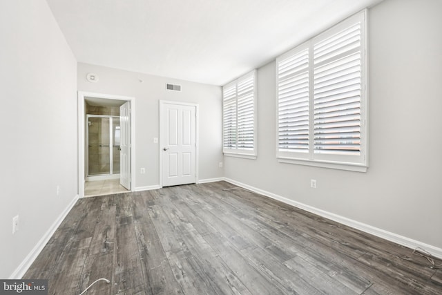 4480 Market Commons Dr Unit 416, Fairfax, VA 22033 - unfurnished bedroom featuring wood finished floors, baseboards, and connected bathroom