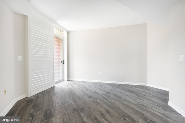 4480 Market Commons Dr Unit 416, Fairfax, VA 22033 - unfurnished bedroom with dark wood-style flooring, access to exterior, and baseboards