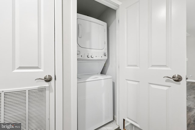 4480 Market Commons Dr Unit 416, Fairfax, VA 22033 - washroom with stacked washer / dryer and wood finished floors