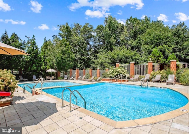 4480 Market Commons Dr Unit 416, Fairfax, VA 22033 - community pool featuring a patio area and view of scattered trees