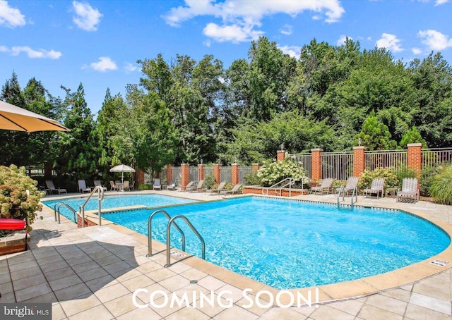 4480 Market Commons Dr Unit 416, Fairfax, VA 22033 - community pool with a patio area and view of wooded area