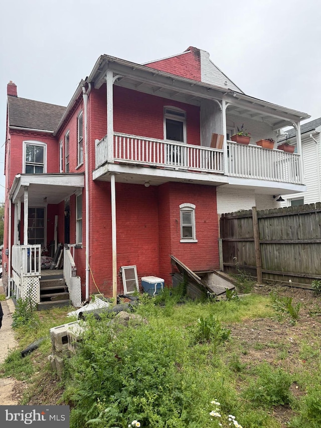 567 S Christian St, Lancaster, PA 17602 - back of property featuring brick siding, a balcony, and a chimney