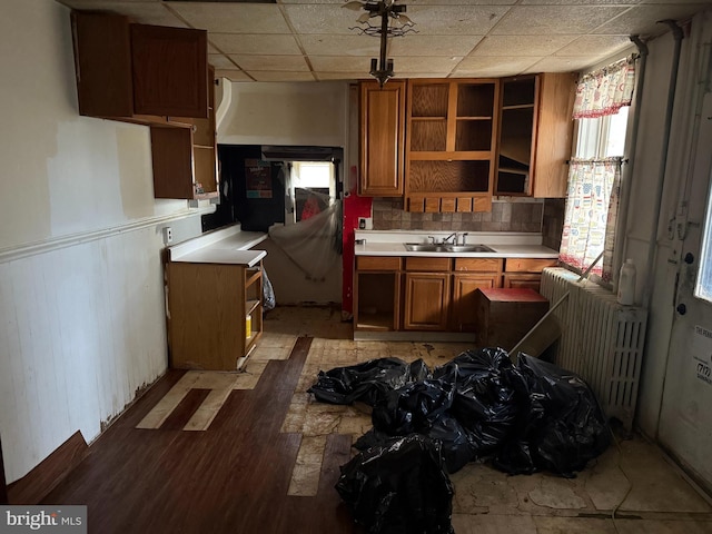 567 S Christian St, Lancaster, PA 17602 - kitchen featuring open shelves, radiator, brown cabinetry, light countertops, and a sink