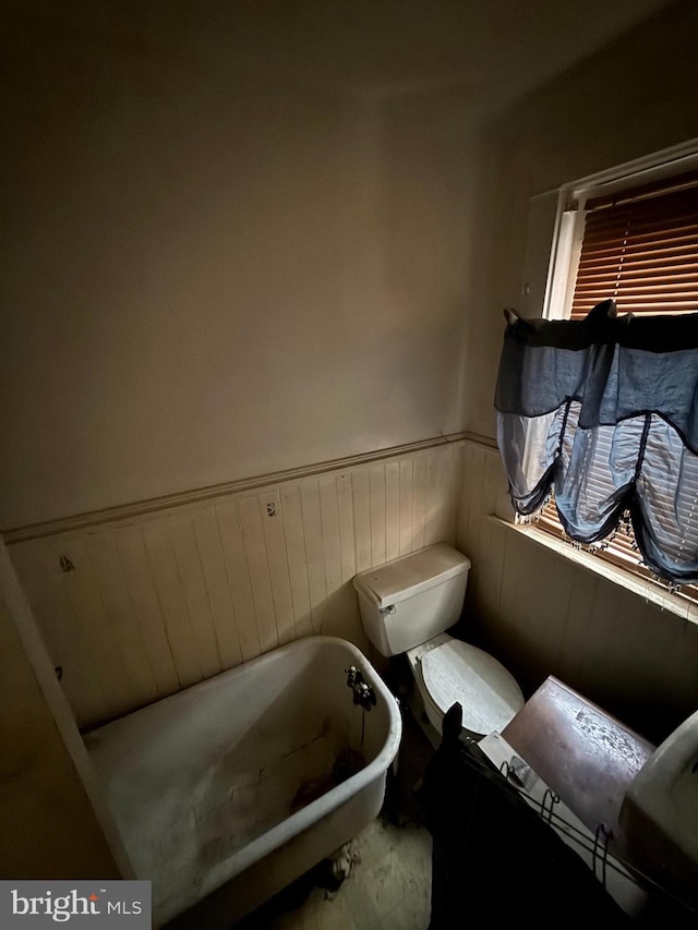 567 S Christian St, Lancaster, PA 17602 - bathroom with a freestanding tub, a wainscoted wall, and toilet