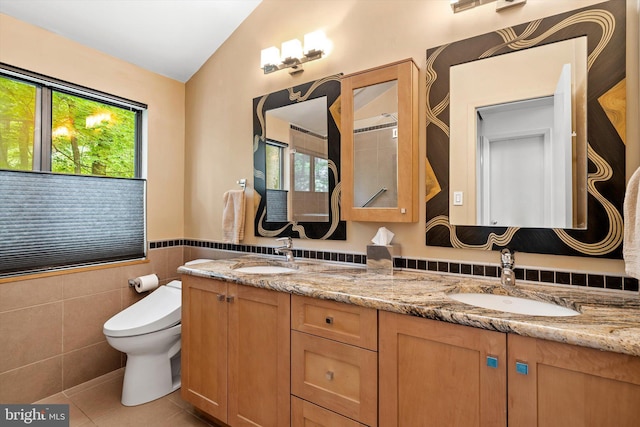 1163 Stuart Rd, Princeton, NJ 08540 - full bath featuring double vanity, tile patterned floors, tile walls, toilet, and vaulted ceiling