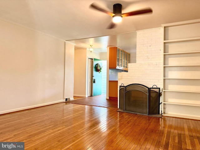 7200 Highland St, Springfield, VA 22150 - unfurnished living room with hardwood / wood-style floors, ceiling fan, baseboards, ornamental molding, and a fireplace