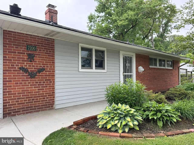 7200 Highland St, Springfield, VA 22150 - view of exterior entry with brick siding and a chimney