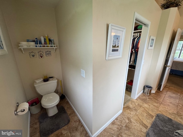 7 Red Fox Ct, Reinholds, PA 17569 - bathroom featuring toilet, a walk in closet, and baseboards