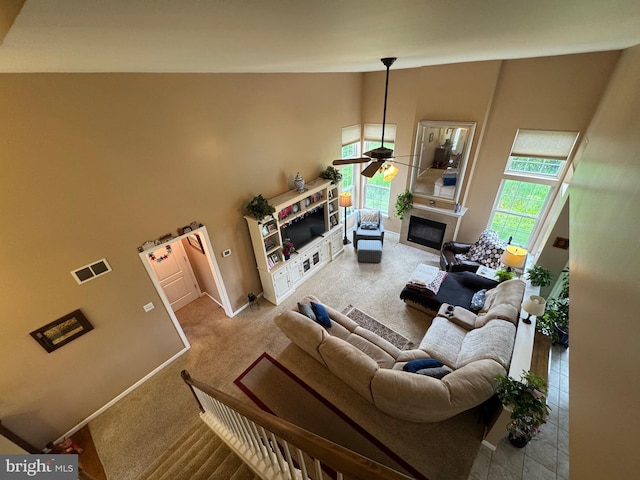 7 Red Fox Ct, Reinholds, PA 17569 - carpeted living area featuring ceiling fan, a high ceiling, a glass covered fireplace, and baseboards