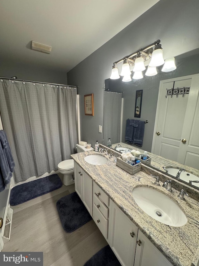 7 Red Fox Ct, Reinholds, PA 17569 - bathroom featuring double vanity, wood finished floors, toilet, and a shower with curtain