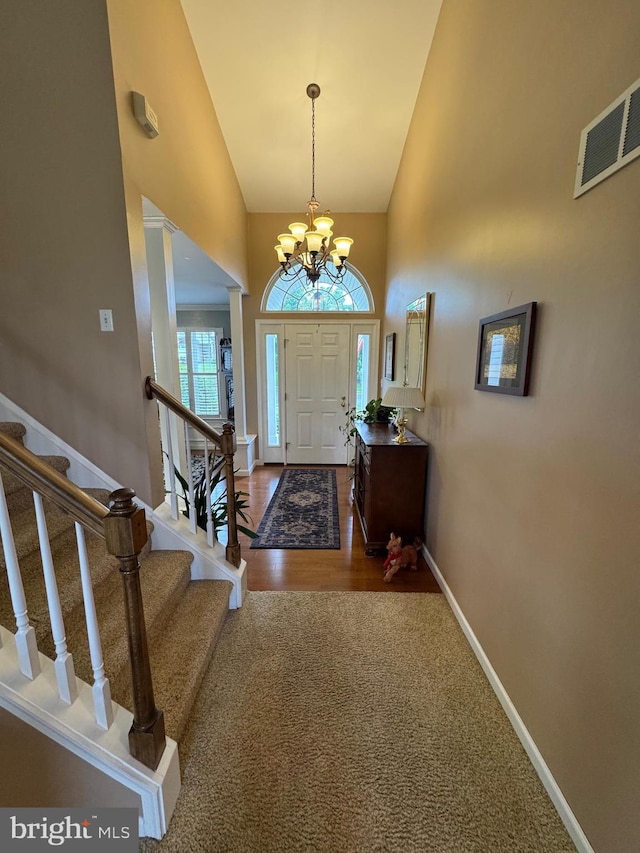7 Red Fox Ct, Reinholds, PA 17569 - entrance foyer featuring a chandelier, stairway, a towering ceiling, baseboards, and wood finished floors