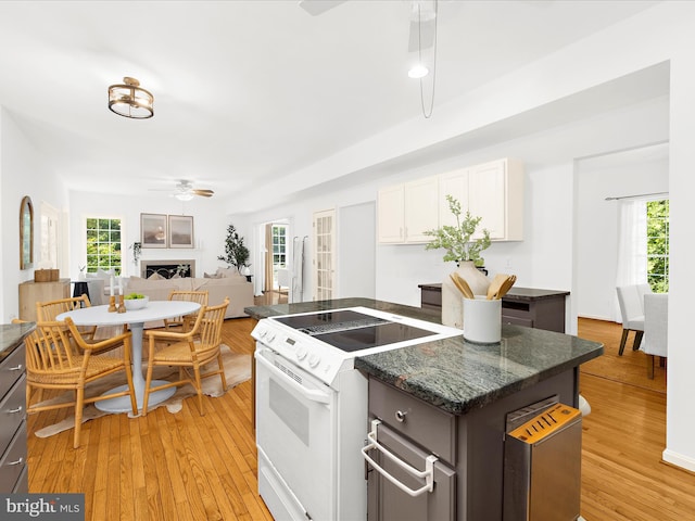 3501 Marthas Vineyard Way, Edgewater, MD 21037 - kitchen featuring white range with electric stovetop, a ceiling fan, light wood-type flooring, a kitchen island, and white cabinets