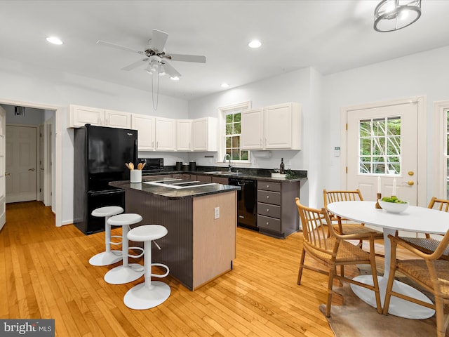 3501 Marthas Vineyard Way, Edgewater, MD 21037 - kitchen with black appliances, a sink, a center island, dark countertops, and white cabinets