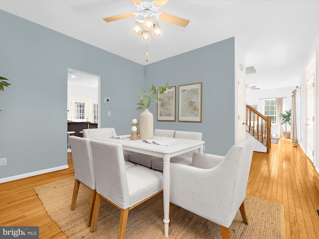 3501 Marthas Vineyard Way, Edgewater, MD 21037 - dining room featuring a ceiling fan, light wood-style floors, stairs, and baseboards