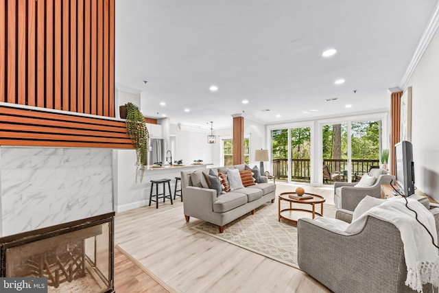 1104 Back Creek Loop Unit 1104, Solomons, MD 20688 - living area with ornamental molding, recessed lighting, plenty of natural light, light wood-style floors, and baseboards