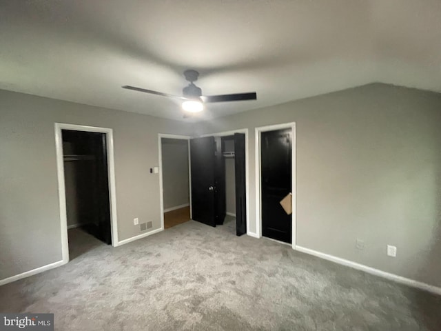 29075 Autumnwood Dr, Mechanicsville, MD 20659 - unfurnished bedroom featuring two closets, carpet floors, baseboards, ceiling fan, and lofted ceiling