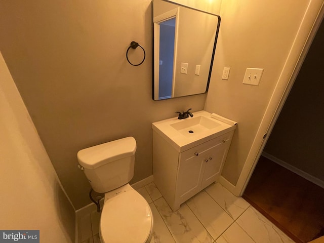 29075 Autumnwood Dr, Mechanicsville, MD 20659 - half bathroom featuring vanity, toilet, marble look tiles, and baseboards