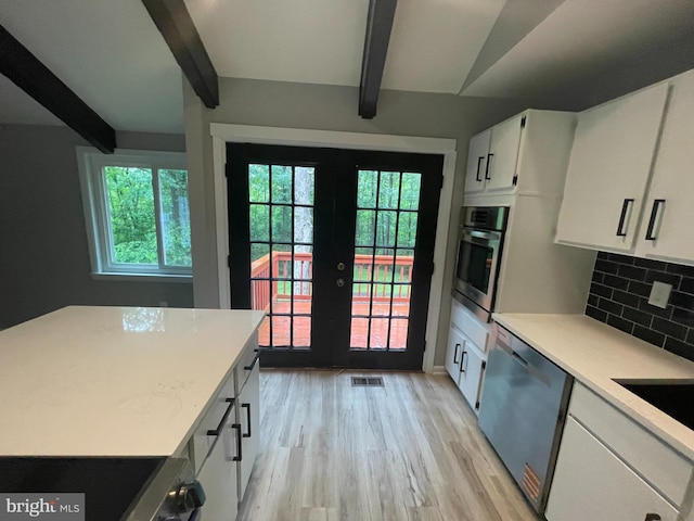 29075 Autumnwood Dr, Mechanicsville, MD 20659 - kitchen with stainless steel appliances, beam ceiling, french doors, decorative backsplash, and light wood finished floors