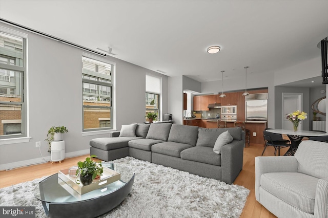 2425 L St NW Unit 623, Washington, DC 20037 - living area featuring light wood finished floors and baseboards