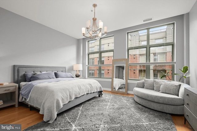 2425 L St NW Unit 623, Washington, DC 20037 - bedroom featuring a chandelier, wood finished floors, and lofted ceiling