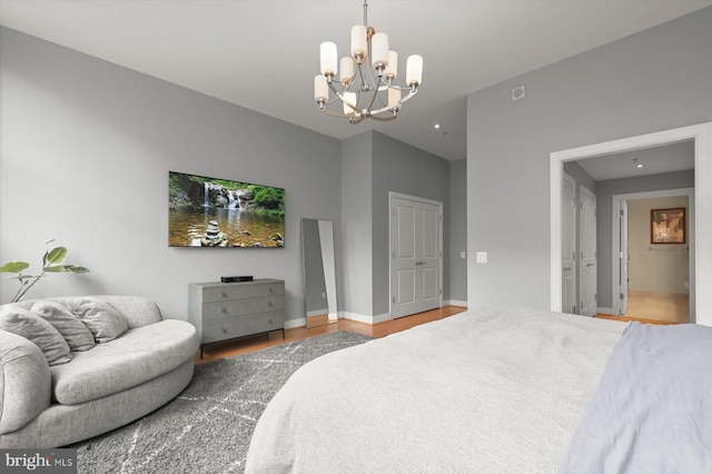 2425 L St NW Unit 623, Washington, DC 20037 - bedroom with a chandelier, wood finished floors, and baseboards