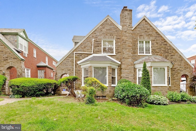 418 Wadsworth Ave, Philadelphia, PA 19119 - view of front facade featuring stone siding, a front lawn, and a chimney
