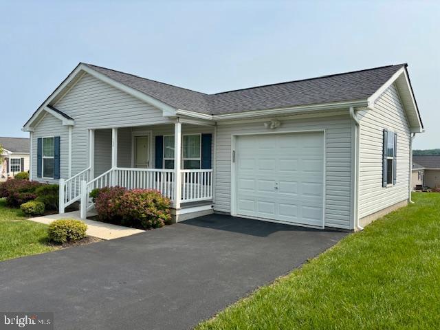 132 Westin Rd, Douglassville, PA 19518 - ranch-style house featuring covered porch, a garage, driveway, a shingled roof, and a front yard