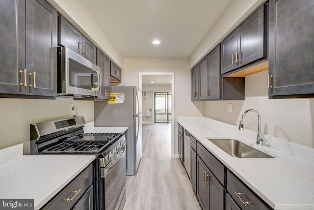 5241 W Running Brook Rd Unit 302, Columbia, MD 21044 - kitchen featuring stainless steel appliances, a sink, light wood finished floors, recessed lighting, and light stone countertops