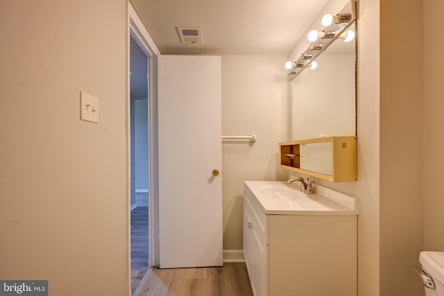 5241 W Running Brook Rd Unit 302, Columbia, MD 21044 - bathroom with vanity, wood finished floors, toilet, and baseboards
