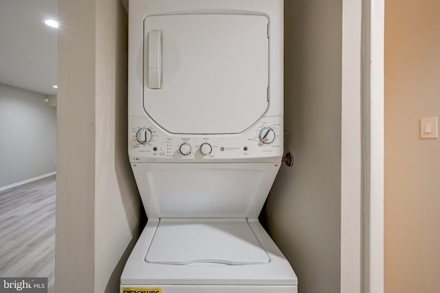 5241 W Running Brook Rd Unit 302, Columbia, MD 21044 - washroom featuring stacked washer / dryer and light wood finished floors