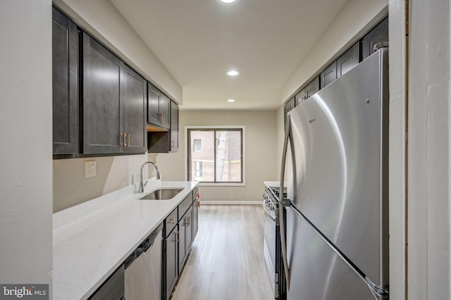 5241 W Running Brook Rd Unit 302, Columbia, MD 21044 - kitchen with stainless steel appliances, a sink, light wood finished floors, recessed lighting, and light stone counters