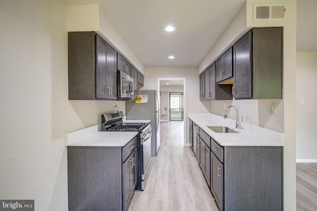 5241 W Running Brook Rd Unit 302, Columbia, MD 21044 - kitchen with stainless steel appliances, a sink, light wood-style floors, light countertops, and recessed lighting